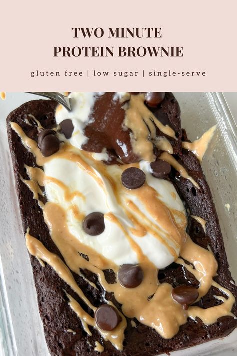 This healthy two minute protein brownie is gluten free, refined sugar free, low carb, low sugar, and high protein. On a small white plate is a single-serve protein brownie in the shape of a rectangle. The outside is a rich dark chocolate color looking soft, gooey in the center, pillowy, and fudgy. Some powdered monkfruit is white sprinkled on top. A fork has a bite on it showing the inside texture of soft, chewy, and airy. Bariatric Low Carb High Protein, Healthy Diet Desserts, Protein Snacks No Protein Powder, Gluten Free Protein Brownies, High Protein Brownie Batter, Vanilla Protein Dessert Recipes, Things To Make With Vanilla Protein Powder, High Protein After Workout Snacks, Gluten Free Protein Desserts