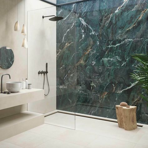 Discover the elegance of the Deluxe Green tile, a bold statement in luxury with its striking dark green marble effect and detailed, multi-tonal veining that adorns its highly polished, porcelain build. Perfect for creating an opulent atmosphere on interior walls and floors, these large format 1200x600mm tiles, with a 10. 5mm thickness, promise durability and timeless beauty. Marble Look Tiles In Bathroom, Onyx Tile Bathroom Wall, Green Porcelain Tile Bathroom, Tiled Floor And Wall Bathroom, Big Tiles In Bathroom, Green Marble Tiles Bathroom, Feature Shower Wall Tiles, Bathroom With Dark Green Tiles, Bathroom Ideas Green And Gold