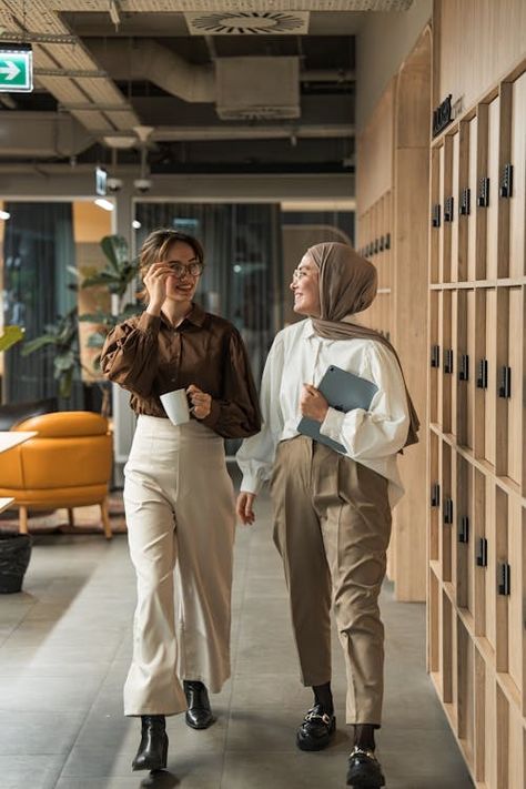 Two women walking down a hallway in an office building · Free Stock Photo Working With Women, Casual Corporate Photoshoot, Office Photo Shoot Ideas, Office Team Photoshoot Ideas, Company Group Photo, Office Shoot Ideas, Group Office Photos, Office Photography Ideas, Work Team Photos