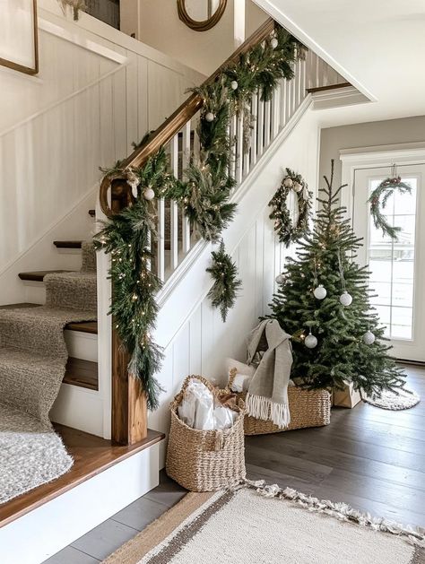 Elevate your home's entrance with stunning christmas staircase decor that makes lasting impressions. From cascading lights to festive ornaments, discover how to create magical moments. Find inspiration among 25 expertly curated design concepts for your perfect holiday display. Christmas Home Entrance, Farmhouse Christmas Staircase, White Christmas Staircase Decor, Staircase Decor For Christmas, Decorating A Bannister For Christmas, Stockings Staircase, Expensive Christmas Decor, Winter Staircase Decor, Christmas Stairway Decor