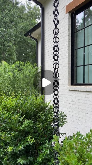 Kelly Jones on Instagram: "We’ve been putting some finishing touches on the flip house. One was installing a rain chain on the front porch just like the one we have on ours. Link in bio for full tutorial." Chain Water Drain, Rain Water Chain, Rain Chain Base Ideas, Rain Catcher Chain, Chain Gutter Downspout, Diy Rain Chain Dollar Stores, Chain Rain Gutters, Tiny Front Porch Decor, Rain Chains Gutter Downspout Ideas