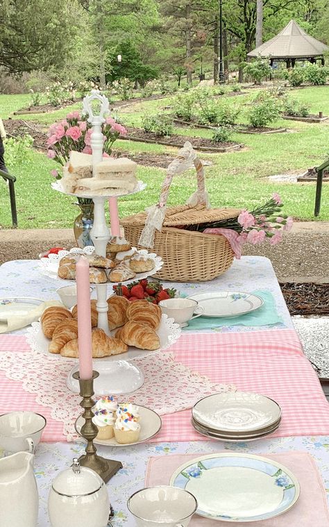 Tapered candlesticks, gingham table cloth. Cupcakes, scones, and tea sets. Pastel Pink And Blue Birthday Party, Fairy Garden Picnic Party, Tea Picnic Party, Pastel Tea Party Decorations, Vintage Picnic Birthday Party, Tea Party Picnic Aesthetic, Pink Tea Party Decorations, Pastel Picnic Party, Outdoor Tea Party Decorations