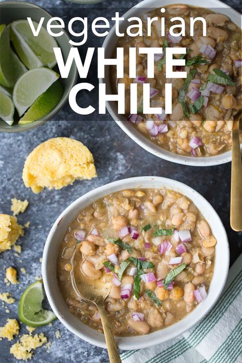 A bowl of vegetarian white chili with lime slices and cornbread. The text reads, "vegetarian white chili." Vegetarian White Bean Chili Recipe, White Bean Sweet Potato Chili, White Bean Chili Vegan, Vegetarian White Chili Crockpot, White Chili Recipe Vegetarian, Vegan Chili Recipe Crock Pot, Vegan White Bean Chili Recipe, Vegan White Chili, Vegetarian White Chili Recipe