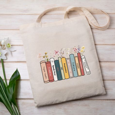 Tote Bag for book lovers, Books as Album Tote Bag, Taylor Swift Lover Tote Bag Different Colors Available Check the link in the bio for details. Custom Bookshelf, Books Tote Bag, Trending Totes, Handpainted Tote Bags, Aesthetic Tote Bag, Floral Tote Bag, Painted Tote, Book Tote Bag, Craft Day