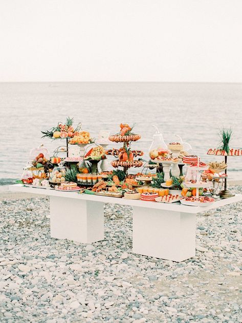 Hold up. You do not want to miss this pebbled coast wedding inspiration overflowing with with details in every shade of citrus. From the intimate shoreside table that sits beneath a dreamy cabana to the fluttery Berta gown with layers of romantic tulle, we are hooked on this vision forever. Color and modern whimsy forever! #ruffledblog Beach Catering Ideas, Wedding Food Beach Theme, Food For Beach Wedding, Beach Wedding Catering, Beach Wedding Food Stations, Seafood Bar Wedding, Wedding Food Seafood, Beach Wedding Appetizers, Beach Wedding Menu Ideas Food