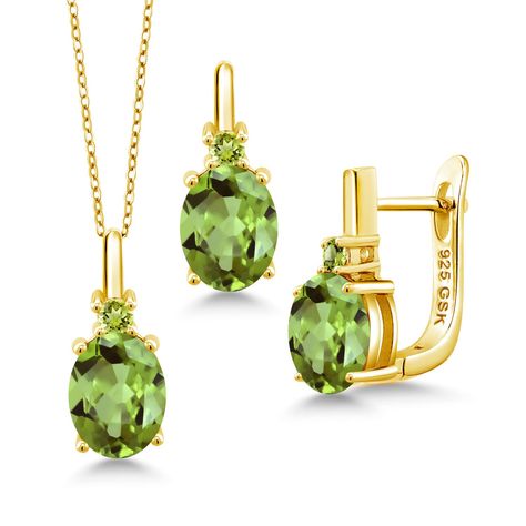 PRICES MAY VARY. Peridot Elegance Set: Elevate your style with the captivating allure of this pendant necklace and earrings set. Featuring a total weight of 6.37 Cttw with Oval 9X7MM Green Peridot gemstones, it radiates natural elegance and sophistication. Craftsmanship in Gold Plated Silver: Meticulously crafted from genuine 925 Sterling Silver with an 18K Yellow Gold Plating, this set showcases exceptional artistry and durability. The oval peridot gemstones and classic design create a harmonio Peridot Jewelry Set, Peridot Jewelry, Peridot Pendant, Peridot Earrings, Peridot Gemstone, Green Peridot, Green Gemstones, Gem Stone, Gold Plated Silver