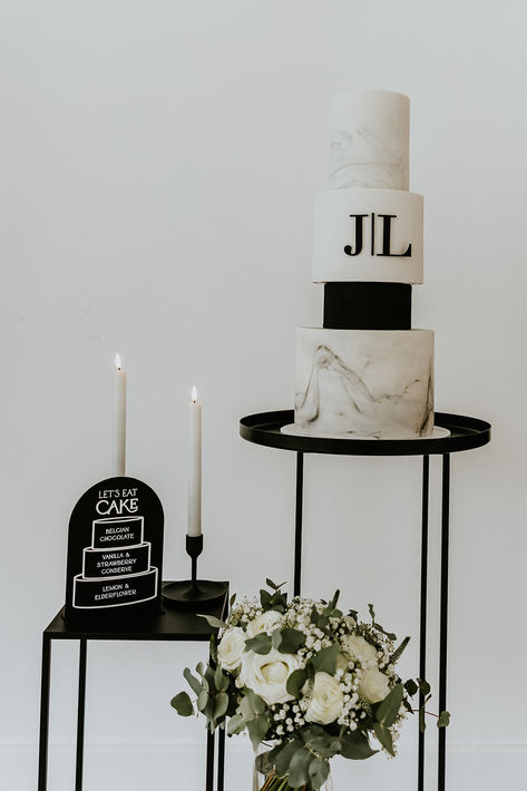 Four tier black and white marble wedding cake with monogrammed initials for the bride and groom next to black and white signage showing the different flavours of the cake | wedding cake design | monochrome wedding cake | traditional iced wedding cake | Lee Daniels Photography Marble Cake Wedding, Modern Black And White Wedding Cake, Wedding Cake With Black Accents, Black And White Wedding Cake Elegant, White Marble Wedding Cake, Black And White Signage, White Signage, White Marble Wedding, Iced Wedding Cake