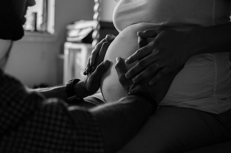 Maternity Photo shoot: black & white photo of pregnant woman and her husband. He is facing her with both hands on her belly. Her hands are resting on his. Husband Hand On Pregnant Belly, Husband Touching Pregnant Belly, Holding Pregnant Belly, Pregnant Woman With Husband, Pregnant Belly Photography, Julia Wolf, Prenatal Health, Pregnancy Belly Photos