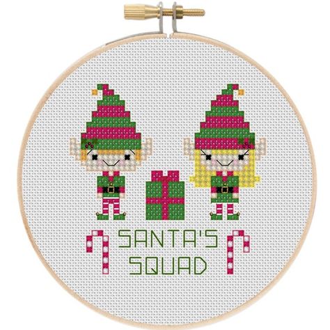 Add some Christmas festivity to your decor with this cute Christmas elf cross stitch pattern! Its the perfect size to make an embroidery hoop ornament! ~Dimensions: 14 count Aida: 2.6 x 2.6 16 count Aida: 2.25 x 2.25 18 count Aida: 2 x 2 ~Thread requirement: 11 DMC floss colors ~Aida color Elf Cross Stitch, Cross Stitch Christmas Gifts, Ornament Cross Stitch, Knit Stocking, Tiny Cross Stitch, Wedding Cross Stitch, Christmas Elves, Holiday Cross Stitch, Xmas Cross Stitch