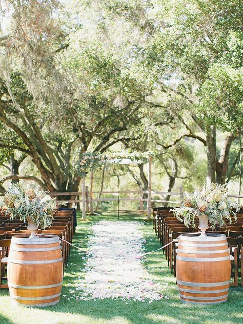 Usher the bride down a rustic wedding aisle with wooden wine barrels decked out in cascading florals or lush garlands. Fall Wedding Vineyard, Vineyard Wedding Decor, California Winery Wedding, Wooden Barrels, Vineyard Weddings, Equestrian Wedding, Aisle Decorations, Rustic Italian, Wedding Ceremony Photos