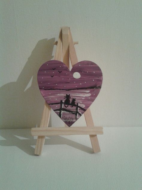 Cat silhouette on a fence painted on wooden heart Painting On A Heart Shape Canvas, Heart Wood Painting, Painted Wood Hearts, Painting On Heart Shaped Canvas, Heart Shaped Painting, Painted Hearts On Wood, Wooden Heart Painting Ideas, Heart Shaped Canvas Painting Ideas, Wood Heart Crafts