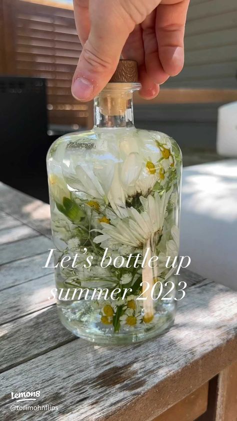 DIY Summer in a bottle ✨ | Article posted by torimohnflips | Lemon8 Flowers In Baby Oil, Housewarming Party Decorations, Angel Baby Shower, Summer In A Bottle, Bottle Centerpieces, Wildflower Baby Shower, Flower Bottle, Easy Christmas Wreaths, Bridal Shower Inspiration