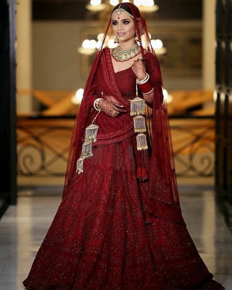 It’s a timeless piece that just never goes out of style. Best Bridal Lehenga Maroon, Jewelry With Red Lehenga, Red Dupatta For Bride, Maroon Chooda Designs Brides, Lehnga Designs 2023, Maroon Lengha, 2023 Lehenga, Latest Lehnga Designs, Maroon Bridal Lehenga