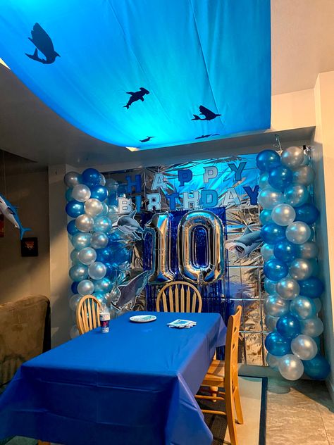 Shark theme birthday party decorations for my 10-year old son who loves SHARKS! Birthday sign, ocean silhouette and balloons all DIY by me. #shark #birthday #decor #diy #ocean Great White Shark Birthday Party, Shark Birthday Party Decorations Diy, Shark Birthday Party Aesthetic, Megalodon Birthday Party, Ocean Decor Party, Megalodon Shark Birthday Party, Marine Birthday Theme, Shark Party Ideas Decoration, Marine Biologist Birthday Party