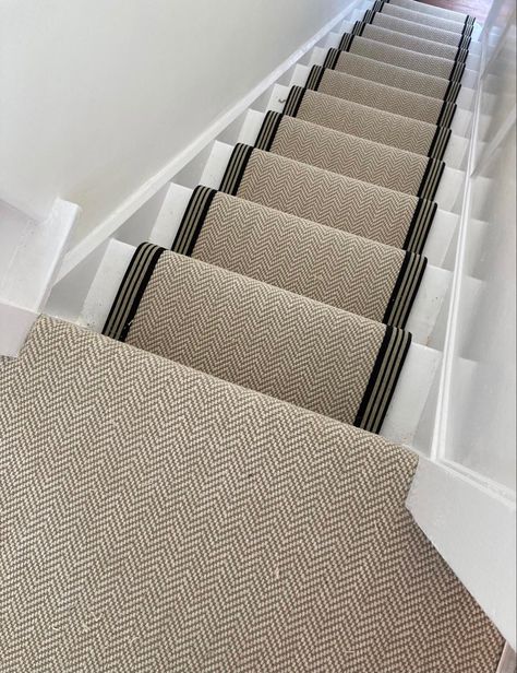 Chalk Herringbone carpet fitted to the stairs as a stair runner and fully fitted on the landing area. The stairs are painted white and the runner is edged in a black and cream stripe tape. Stair Runner Hallway, Modern Staircase Runner Ideas, Staircase Ideas Carpeted Runner, Herringbone Sisal Stair Runner, Stair Runner Carpet Top Of Stairs, Herringbone Runner Stairs, Cream And Black Hallway, Black And Cream Hallway, Striped Stair Carpet