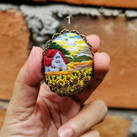 Mini scenery painting in a brooch frame, that's the theme of these accessories . This embroidered brooch is available to purchase on my Etsy shop : https://kniahandmade.etsy.com (Click for the link in my bio) ---- #bordir #stitches #ribbonembroidery #stitchembroidery #embroideredbrooch #embroiderybrooch #handmadebrooch #vintagebrooch Diy Embroidered Brooch, Brooch Frame, Gold Embroidered Brooch For Gift, Beaded Embroidery Portrait, Unique Embroidered Brooch For Gift, Beaded Earth Brooch, Scenery Painting, Embroidered Brooch, Diy Embroidery Patterns