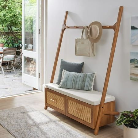 Streamline your entryway with the Better Homes & Gardens Springwood Entryway Tree. Crafted from laminated particleboard, this bench exudes a trendy vibe with its charming woodgrain finish and rattan drawer fronts. Utilize the five chunky wood knobs for hanging coats, scarves, and bags, while the two deep drawers effortlessly organize shoes and accessories. The leaning ladder design, coupled with minimalistic features and an open back, enhances the overall aesthetic. Take a seat on the padded bench while slipping on your shoes. For added stability, the entryway hall tree includes a wall anchoring kit. Delivered flat to your door, assembly is required upon arrival, and we recommend the hands of two adults for the task. Assembled dimensions: 68.7"H x 54"W x 18.34"D. Color: Black. Mid Century Modern Entryway Bench, Entryway Bench And Storage, Key Table Entry Small, Entry Hall Tree Ideas, Mail Station Entryway, Drop Station Entryway Small Spaces, Entryway Tree Bench, Eclectic Entryway Table, Foyer Bench Decor