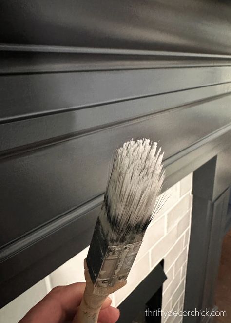 Painted Fireplace Surround and More Living Room Updates | Thrifty Decor Chick | Thrifty DIY, Decor and Organizing Black Faux Fireplace Mantel, Fireplace Mantel Makeover Diy, Wood And Black Fireplace, Gray Fireplace Surround, Diy Black Fireplace Surround, Fireplace Surround Ideas Diy, Dark Painted Fireplace Wall, Black Fireplace And Mantle, Cracked Pepper Fireplace