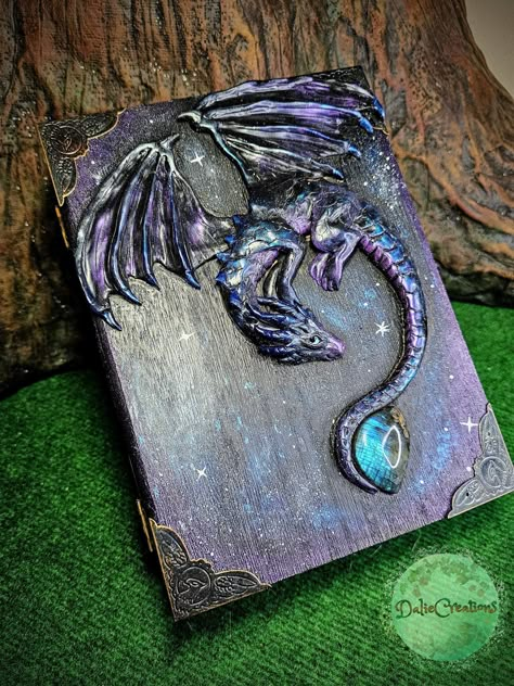 You are buying an accurately photographed piece, you buy a Dragon jewerly box that is in the photos . Decorative jewelry box Magic book of Galaxy Dragon . The Dragon Book is a powerful item containing the magic of the depicted dragon that caresses through the cover of the book.. . The book was created by wrapping polymer material on raw, processed wood. Painted parts where acrylic was used are painted with varnish for color stability. Inside of box is Felt padding . Labradorite are used in the m Dragon Spell Book, Galaxy Dragon, Dragon Books, Magical Objects, Dragon Box, Dragon Book, Dragon Designs, Fantasy Craft, Dragon Stuff