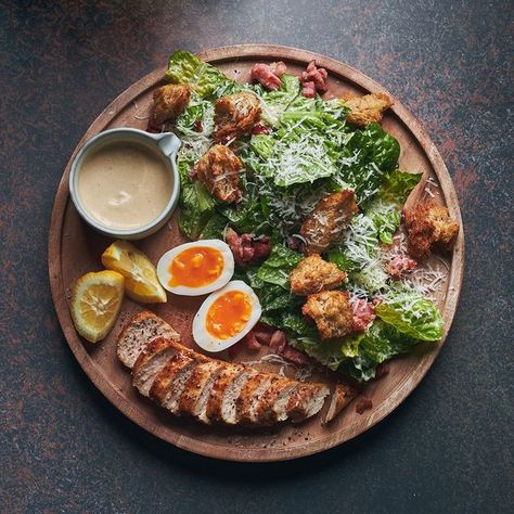 Artistry JHB on Instagram: "A Ceasar Salad with an #ArtistryJHB twist. Featuring chopped greens, parmesan, capers, sourdough croutons, egg and the classic Caesar dressing, enjoy this flavourful menu item on The Rooftop once we open early, 2023. #Artistry #TheArtistryExperience #CelebrateLife #CelebrateMoments #ArtAndCulture #ArtLovers #Foodies #FoodiesOfSA #CulturalFusion #Sandton" Caesar Salad Plating Ideas, Ceasar Salad Plating Ideas, Yacht Food, Salad Plating, Sourdough Croutons, Salad Presentation, Parmesan Salad, Yacht Week, Italian Menu