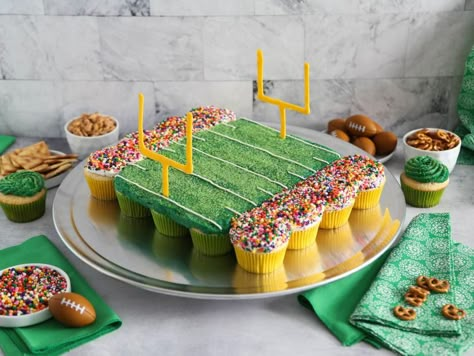 Football Stadium Pull Apart Cupcake Cake Recipe | Heather Baird | Food Network Football Party Cupcake Ideas, Football Cake Recipe, Sports Themed Cupcake Cake, Cupcake Football Cake, Sports Cupcake Cake, First Down Football Birthday Party Cake, Football Birthday Party Food Ideas, Football Birthday Cake Ideas, Football Themed Cupcakes