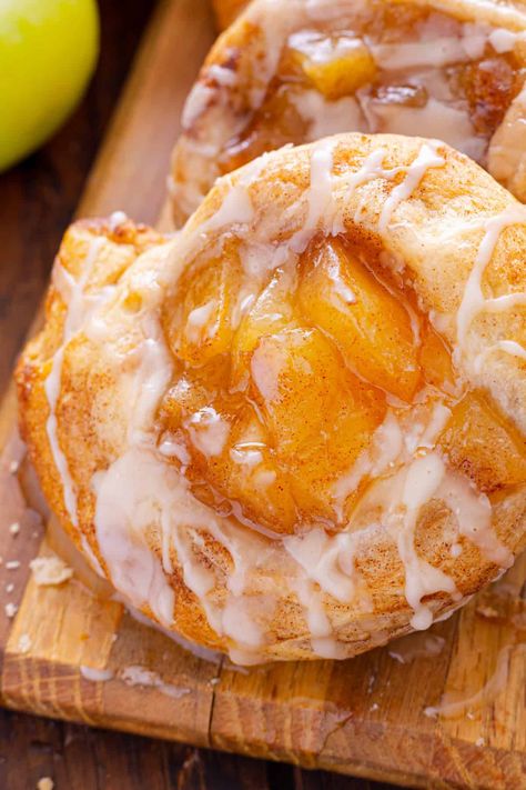 This Apple Danish recipe offers two options for making danishes - with crescent rolls or puff pastry with cream cheese. Both result in an irresistible dessert with apple pie filling and a sweet glaze on top. Caramel Apple Danish, Easy Apple Danish Recipe, Apple And Cream Cheese Danish, Apple Pie Danish Recipe, Apple Breakfast Pastries, Apple Pillsbury Crescent, Pineapple Danish Recipe, Fruit Filled Crescent Rolls, Cherry Danish Puff Pastry