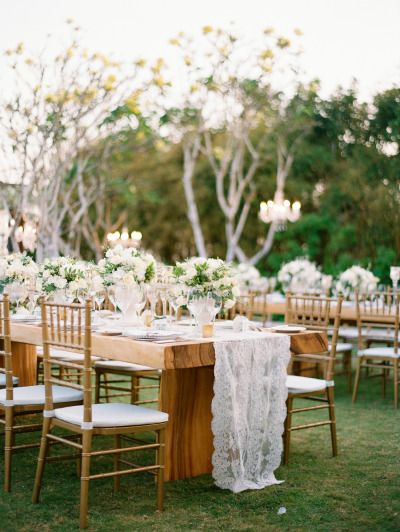 Outdoor Bali wedding table: http://www.stylemepretty.com/2014/10/06/classic-white-wedding-in-bali/ | Photography: Angga Permana - http://anggapermanaphoto.com/ White Flower Centerpieces, Burlap Lace Wedding, Wedding In Bali, Indonesian Wedding, Reception Tablescapes, Lace Table Runners, Bali Wedding, Vintage Wedding Decorations, Wedding Tables