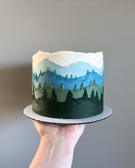 🤍🩵💙💚 • • Order mountain view cakes on our website 🔗 in bio! • • #Buttercreamcakes #buttercreamcake #buttercream #buttercreamart #customcake #cakedecorating #cakestagram #cakedesign #instacake #cakeideas #vermontbakery #vermontbaker #homebaker #homebakery #bakergram #vermont #madeinvermont #madeinvt #shelburnevermont #shelburnevt #bluehousebakeshop #cake #baker #pastrychef Smokey The Bear Cake, Buttercream Mountain Cake, Small Mountain Wedding Cake, Woodsy Cake Ideas, Hiking Cake Ideas, Nature Themed Cake, Pine Tree Cake, Mountain Cakes, Woodsy Cake