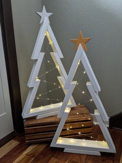 These sleek and charming wooden Christmas trees are handmade from 100% wood and built to last! Large trees: https://www.etsy.com/listing/1553104627 Extra extra large trees: https://tranquiltimber.etsy.com/listing/1575275994  Short & Robust and Tall & Slim trees: https://www.etsy.com/listing/1599578115 Looking for a rustic one of a kind tree: https://www.etsy.com/listing/1585352590 What makes these trees premium: *Indoor/outdoor use *High quality wood stain *Spar urethane for UV protection, mold Homemade Wood Christmas Decorations, Wood Christmas Outdoor Decorations, Light Up Wooden Christmas Tree, Painted Wood Trees Christmas Decorations, Wooden 2x4 Christmas Tree, Wooden Christmas Trees With Lights, Wooden Christmas Trees Front Porch, Christmas Decor Made From Wood, Wooden Christmas Tree With Lights