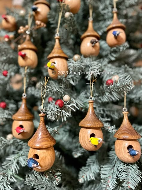 "Birdhouse ornaments hand turned in the USA from solid oak with an Ebony perch and miniature bird. Add some life to your Christmas tree, holiday display, or year-round home decor with our unique handcrafted birdhouse ornaments. These eye-catching ornaments will provide a lifetime of enjoyment.  - Every order comes shipped in a gift box with bubble wrap and our logo on top. - Birdhouse body and roof hand turned from oak - Rectangular perch crafted from sustainably harvested Gaboon Ebony - Gloss p Christmas Lathe Projects, Lathe Christmas Ornaments, Wood Turning Christmas Ornaments, Lathe Crafts, Wood Lathe Projects, Birdhouse Christmas Tree, Birdhouse Ornament, Wooden Christmas Tree Ornaments, Woodturning Ideas