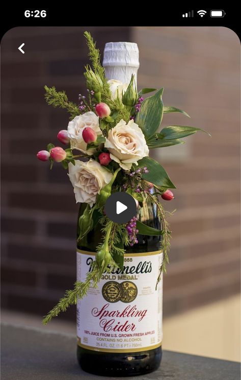 Centerpieces With Bottles, Pretty Finger Foods For Party, Floral Wine Bottle Centerpieces, Corsage Box Ideas, Floral Arrangements With Wine Bottles, Bridal Shower Wine Bottle Centerpieces, Flowers Around Wine Bottle, Fresh Flowers On A Wine Bottle, Wine Bottle With Flowers Centerpieces