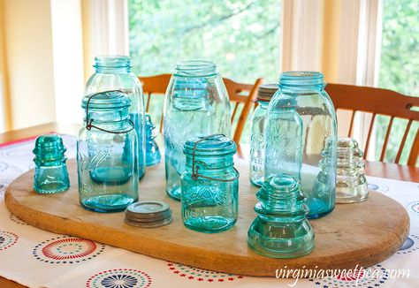 Vintage Ball Jar Centerpiece - Create a beautiful table centerpiece with vintage ball jars and insulators. #vintagecenterpiece #vintageballjars #vintagemasonjars #masonjarideaas Blue Mason Jar Centerpieces, Light Blue Kitchen, Blue Kitchen Designs, Patriotic Table Runner, Ball Canning, Ball Canning Jars, Light Blue Kitchens, Blue Kitchen Decor, Ball Jar