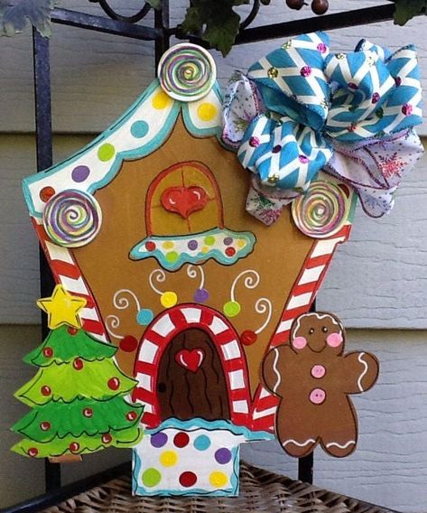 "This adorable and festive gingerbread house was custom designed and laser cut. It is painted with acrylics and sealed with a shimmer finish. There are wood parts: lollipop, heart and stars to add to the theme and create more character to your holiday decor It can come with or without bow . Bow is no extra charge . Due to availability, bow pictured will be substituted to match color theme. It comes in sizes from 12-24\", go to my other listing to choose another size. Personalization is available Gingerbread Door Hanger, Gingerbread Door, Santa Door Hanger, Lollipop Heart, Gingerbread Unit, Santa Door, Amp Storage, Christmas Door Decorating Contest, Storage Chests