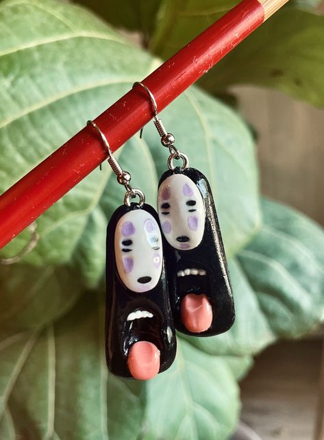 ❣ PRODUCT: Ghibli earring / Faceless figurine / Custom figurine / Spirited Away figurine / Handmade figurine / Handmade earring / Studio Ghibli / Polymer clay earring ❣ PLEASE READ DESCRIPTION FOR MORE INFORMATION: ❣ Hello all Studio Ghibli lovers! If you appreciate the simplicity of craftsmanship and the magical universe of the Ghibli films, these earrings are made for you. Each pair of earrings is handcrafted with lots of love and attention, from polymer clay. They are inspired by the iconic F Ghibli Figurine, Ghibli Polymer Clay, Faceless Character, Studio Ghibli Earrings, Clay Diys, Magical Universe, Custom Figurines, Handmade Earring, Clay Earring