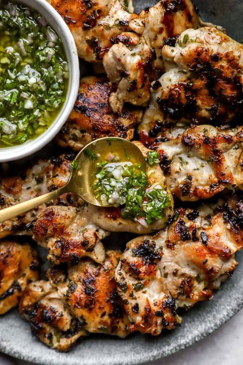 Charred, juicy and so delicious, these grilled Chimichurri Chicken Thighs make for the perfect dinner! Boneless chicken thighs are marinated in chimichurri, grilled up and served with another spoonful of that bright green sauce. This recipe is a summertime-must that is gluten-free, paleo and Whole30-friendly. Big Green Egg Recipes Chicken, Chimichurri Chicken Thighs, Grilled Chicken Thighs Boneless, Grilled Chicken Thigh Recipes, Grilled Whole Chicken, Chimichurri Chicken, Big Green Egg Recipes, Marinated Chicken Thighs, Green Egg Recipes