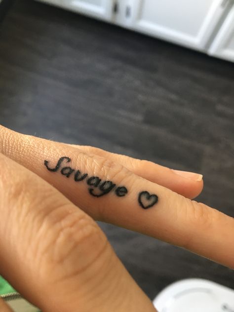 Finger tattoo delicate black tattoo women savage heart ring finger Finger Tattoo Black Women, Middle Finger Tattoo For Women, Finger Tattoo Ideas Female, Inner Finger Tattoos Words, Savage Tattoos For Women, Encouragement Tattoos, Cute Finger Tattoos For Women, Side Finger Tattoos, Inside Finger Tattoos