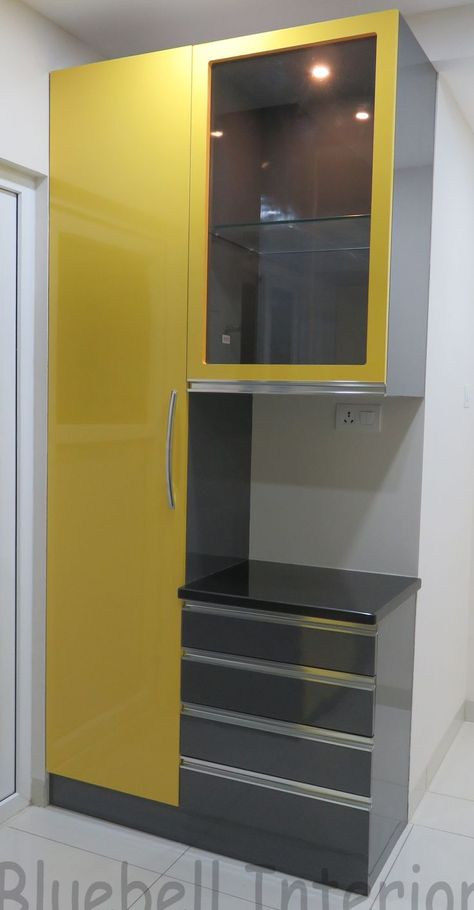 mustard & charcoal kitchen, tall unit, glass shutter with light inside, space for oven in be… | Kitchen design decor, Kitchen furniture design, Crockery unit design Wall Cupboards Design, Desain Pantry Dapur, Dining Room Cupboards, Crockery Cabinet Design, Kitchen Unit Designs, Crockery Cabinet, Crockery Unit Design, Almirah Designs, Modern Cupboard