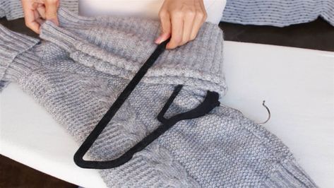 Use this genius method to neatly hang sweaters in your closet without stretching out the material. How To Fold Sweaters, Sweater Hangers, Hang Sweaters, Sweater Hanging, Simple Closet, Shirt Folding, Clothes Organization Diy, Organisation Hacks, Diy Clothes Life Hacks