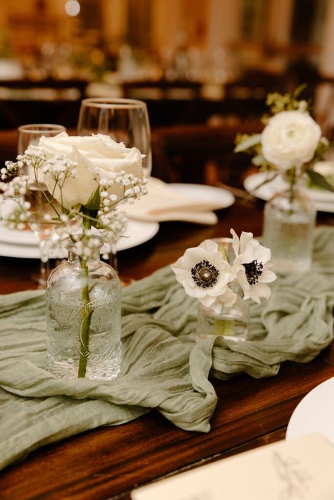 What a gorgeous wedding day it was at the Rock Island Lake Club for Lindsey and Chris! We were absolutely over the moon to share their stunning summer wedding in none other than the enchanting Sparta, New Jersey. Ivory And Sage Wedding Table Setting, Bud Vases Eucalyptus, Bud Vases Wedding Centerpiece White Flowers, Sage Green Table Runner With Eucalyptus, Sage Wedding Reception Decor, White And Green Bud Vases Wedding, Sage Green Vase With Flowers, Little Vases Centerpieces, Simple Green Centerpieces