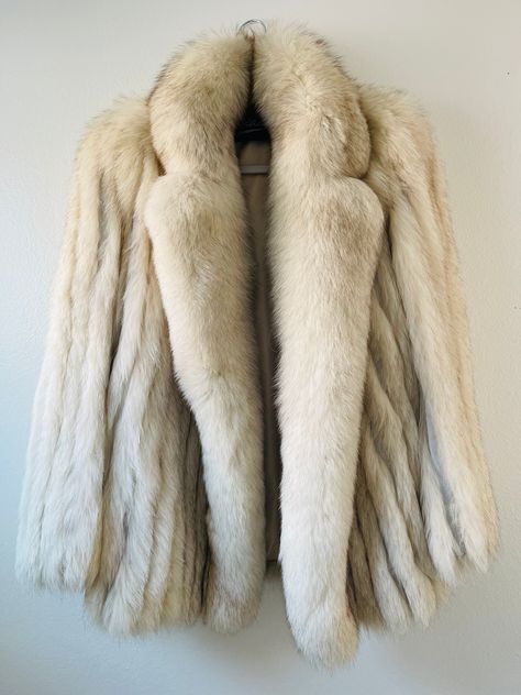 This Gorgeous vintage Saga Blue Fox Norway Fur Coat Jacket is a stunning addition to any wardrobe. The cream tan color and overcoat style make it a timeless piece that never goes out of fashion. It is made of high-quality Blue Fox Fur and lined with Nylon for comfort and durability. please remember that is a size 10 vintage so is easily a S/M  perfect for women who want to stay warm and stylish during cold weather. The jacket was made in Korea, It has a classic design that will never go out of s Saga Fox Fur Coat, Oded Fehr, Vintage Fur Coat, Chic Closet, Fur Coat Fashion, Fur Coat Vintage, Fur Coats Women, Fox Fur Coat, Vintage Fur