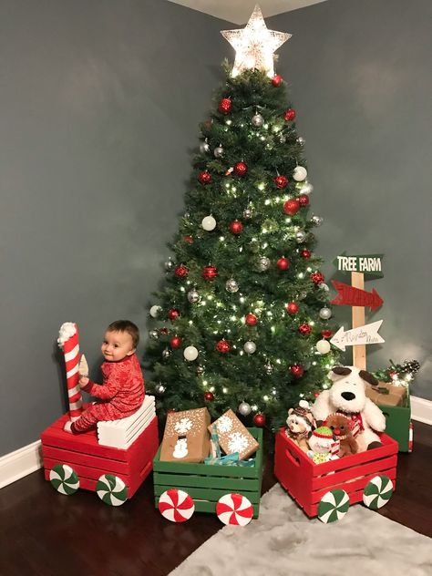 Toy Train Around Christmas Tree, North Pole Diy Decorations, Gift Train Christmas, Santa Presents Under Tree, North Pole Photo Shoot, Christmas Gift Train Diy, Under Christmas Tree Decor Ideas Diy, North Pole Theme Decoration, Santa Village Decorations