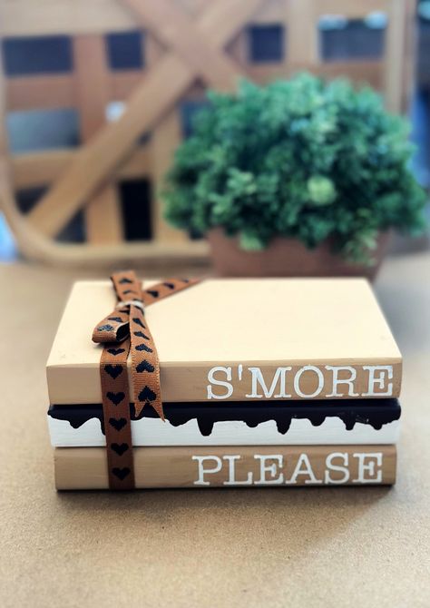 "S'more Please wooden book stack. This adorable farmhouse book stack is perfect for your summer tiered tray decor.  Book stack measures approximately 5\" x 3\" x 3\" and are painted with ribbon added. Blocks are glued together. IMPORTANT NOTICES: By submitting your order, you agree to all shop policies, thank you! I use a third party app to make the QR codes. I am not responsible if there site is down. I will have your message stored indefinitely and it will work again as soon as their site is back up and running! 1. Our processing time varies seasonally, you can see our current processing time by checking the \"shipping & policies\" tab located in this listing, Please be aware that processing time does not including shipping time, so please add 3-5 business days on top of processing time. Stacked Wooden Books Diy, Book Stack Decor Diy, Halloween Stacked Books, Mini Wood Books Diy, Wooden Book Decor, Dollar Tree Tiered Tray Diy, Diy Book Stacks, Summer Crafts To Sell, Fall Book Stacks