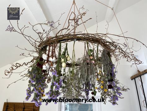 This floral chandelier would look amazing in a marquee or teepee for an enchanting and romantic wedding breakfast.  The flowers used in this design will dry over time and still look beautiful. Dried flowers will add a vintage, bohemian feel to any wedding. The flowers used are red roses, white roses, pink roses, lavender, statice, limonium, craspedia, cotton, hazel, contorted hazel. The colour palette used is dusty lilac and pink with a pop of colour from the deep red roses and yellow craspedia. Apothecary Decor, Flower Chandelier, British Flowers, Floral Chandelier, Event Flowers, The Cotswolds, Garden Art Sculptures, Dried Floral, Rustic Garden Decor