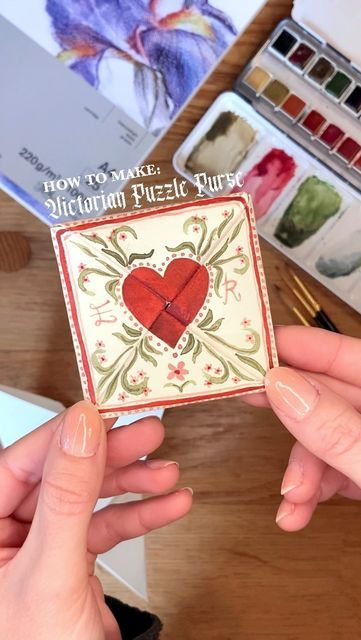 Fennuala Belle on Instagram: "Lots of you asked for a Puzzle Purse tutorial so here it is! This would be a perfect Valentines gift for a loved one 🥰 All you need is some A4 paper (I used thick 220gsm drawing paper as I used watercolour paints to decorate and also wanted to make sure it was durable and wouldn’t fall apart!), scissors, a ruler and paints/decorating materials! The pinwheel step is tricky and took me ages to get my head around when I first tried it so don’t worry if you struggle with this part too, but just keep at it and it will work! The folds just all of a sudden seem to fall into place! The Puzzle Purse I made was a Christmas present for my boyfriend so I included some Christmas decorations as well as some things he and I both love (chess and a cup of tea!) so you co Will You Be My Valentines Ideas, Valentines Puzzle Purse, Valentines Diy Boyfriend, Watercolour Valentine Cards For Him, Folded Valentine Cards, Foldable Valentines Card, Ask To Be Valentine, Paper Valentines Crafts, Victorian Puzzle Purse Design Valentines