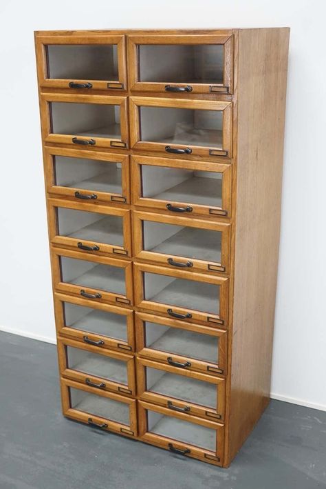 This vintage haberdashery shop cabinet originates from the Netherlands. The piece is made from oak and features 16 drawers...