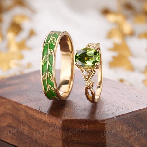 Vintage 2pcs Couple Rings Set Oval Cut Peridot Engagement Ring Yellow Gold Leaf Green Enamel Wedding Band Promise Rings For Men And Women ITEM DESCRIPTION Metal Type: yellow, white or rose solid 14 or 18k gold. Size: All sizes are available, contact me if they do not contain the size you want in the drop-down menu. ❀Women's band    ⊹Center Stone - Peridot    ⊹Side Stone - Moissanite/Diamond      Cut - Round     Weight - 0.03ct     Clarity - SI-VS     Color- G-H    ⊹Band width - 1.5mm ❀Men's band Wedding Band Matching Engagement Ring, Peridot Ring Men, Peridot Ring For Men, Gender Neutral Wedding Ring, Unique Matching Wedding Rings, Unique Green Wedding Rings, Gold And Emerald Wedding Ring, Lord Of The Rings Wedding Ring, Wedding Bands His And Hers Unique