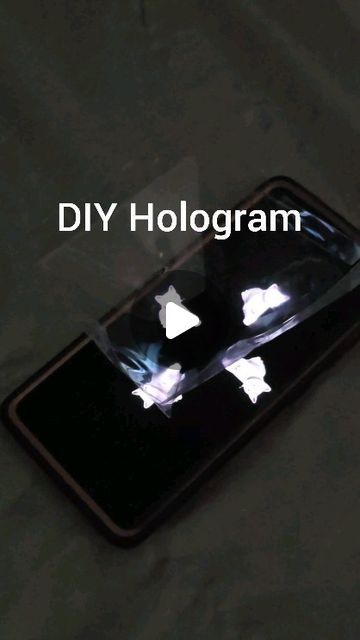 Agnes | Toddler Learning Activities on Instagram: "DIY Hologram

We saw this amazing and easy way to recreate a hologram and was so impressed with the results!

❤️ Use clear plastic (reuse from takeout container lids)

🧡 Cut them into trapezoid shapes (you'll want to make them taller vs flat so that when you tape them together, they make almost a pyramid shape) 

💛 Tape the edges together (use clear transparent tape for better results) You'll now have a pyramid with an empty square in the middle

💚 Place your phone on a table or propped surface

💙 Search for a hologram video and place your pyramid upside down in the middle

💜 Turn off the lights and get down to eye level

❤️ Now watch the magic!

Would your little ones be amazed by this?? 

💌 Save and share with a friend for inspirat Diy Hologram, Hologram Video, Pyramid Shape, Shape Tape, Instagram Diy, Toddler Learning Activities, Toddler Learning, Turn Off, Kids Activities