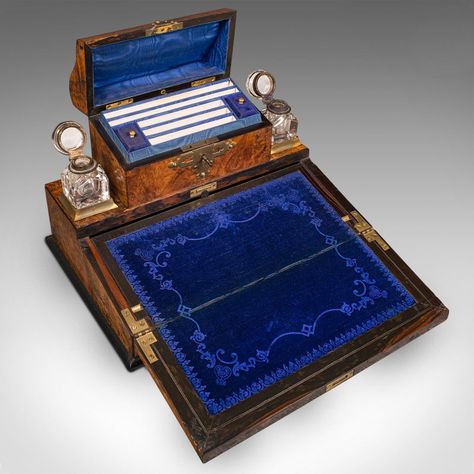 This is an antique desktop writing slope. An English, burr walnut and brass correspondence box, dating to the mid Victorian period, circa 1860.  An attractive and delightfully appointed slope for the desktop Displays a desirable aged patina and in very good condition Striking burr walnut stocks present superb grain interest Rich caramel hues dance beneath a wax polish finish  Domed stationery compartment dressed with a brass twist latch  escutcheon — key present Turning the key operates the dome Writing Slope, Walnut And Brass, Stationary Box, Antique Writing Desk, Blue Items, Secret Box, Victorian Period, Dream House Decor, Writing Desk