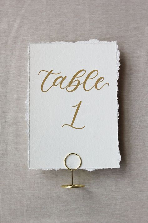 Deckled edge 5x7 table numbers to add to your wedding day or special event. Details: - Deckle edge 140 lb paper - Size is approximately 5"x7" - Writing is professionally printed in black or matte gold ink How to Order: - Select if you want matte gold or black ink - Select the number of table numbers you need - Add to cart! Follow us on social media! @laurentaylorandco Paper Table Numbers, Numbers Calligraphy, Calligraphy Table Numbers, Deckled Edge Paper, Wedding Numbers, Honeymoon Ideas, Paper Table, Event Details, Wedding Vibes