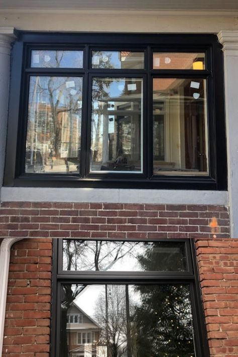 These modern black window frame contrasts well with classic brick. Provides an updated look to a dated fecade. Installed on homes in historic Toronto Canada by Delco Windows and Doors. Black Window Frames Exterior Houses Uk, Black Window And Door Frames, Black Wood Windows, Granite Door Window Frame, Black Picture Windows Exterior, Brick Home Black Windows, Black Grid Windows Exterior, Black Windows Without Grids, Black Pvc Windows